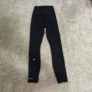 Lululemon black leggings with Lululemon word designs.